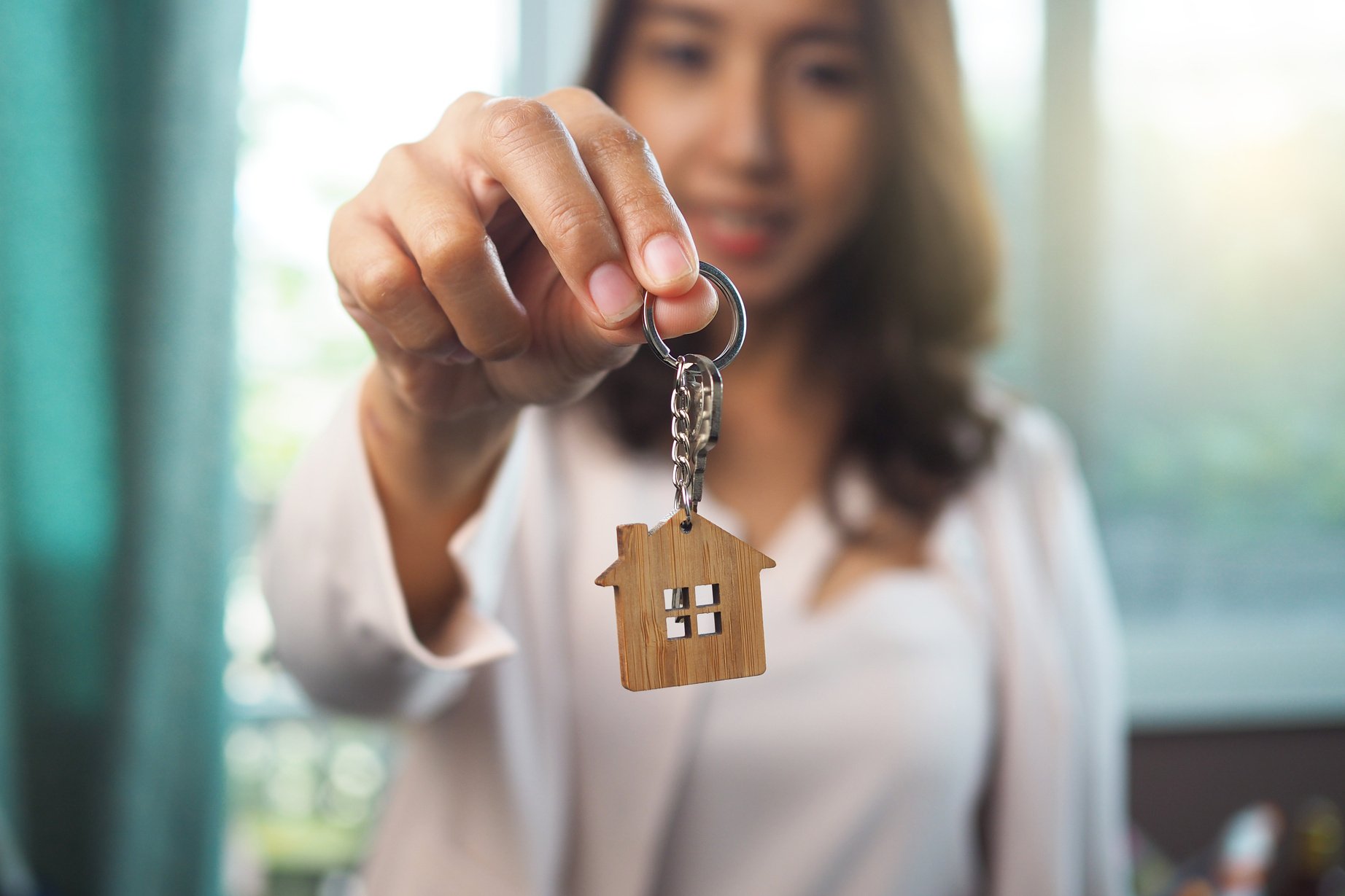 Woman Holding a House Keychain